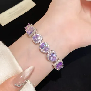 Close-up of elegant purple zircon bracelet with heart and oval shaped stones on wrist