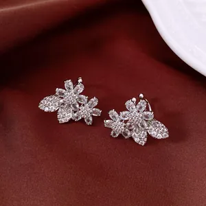 Close-up detail of exquisite silver flower ear cuffs with sparkling cubic zirconia stones