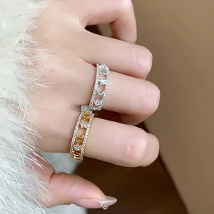 Macro detail of star and moon rings with sparkling pavé zircon stones on fingers