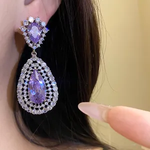 Detail view of a luxurious lavender zircon water drop earring with silver needle.