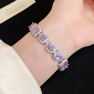 Close-up detail of a silver bracelet with multi-shape purple zircon gemstones