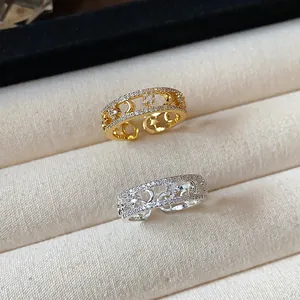 Detailed close-up of 18k gold and silver plated rings featuring star and moon motifs