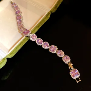 Detailed macro view of a silver-toned bracelet featuring purple heart and square gemstones