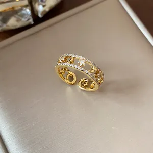 Close-up detail of 18k gold plated ring featuring sparkling star and moon zirconia