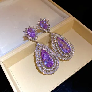Detailed macro view of elegant purple water-drop zircon earrings with hollow silver frame