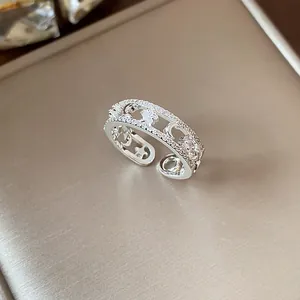 Detailed view of an adjustable silver ring featuring pavé cubic zirconia star and moon motifs.