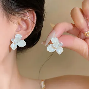Elegant French camellia earrings with pearl finish and micro-set zirconia flower details