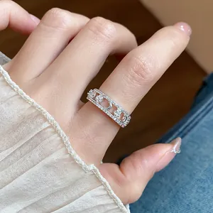 Close-up of 18k gold plated ring with zircon star and moon motifs on finger