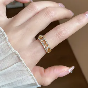 Detailed close-up showing 18k gold plated zircon star and moon ring on a person's hand