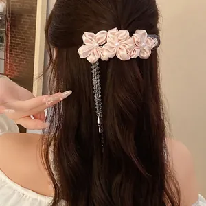 Elegant pink fabric flower hair clip with pearl centers and dangling bead tassels