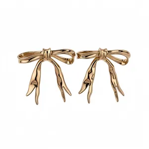 Elegant gold polished bow stud earrings with a minimalist retro design
