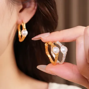 Elegant textured geometric hoop earrings in gold and silver finish with white pearls.