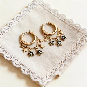 Elegant golden hoop earrings featuring dangling chains and black oil-dripping star charms