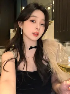 Elegant model wearing long zircon tassel water drop earrings in a luxury setting.