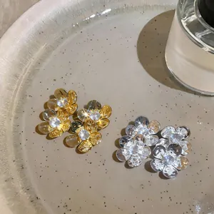 Elegant French style flower stud earrings with sparkling cubic zirconia in gold and silver