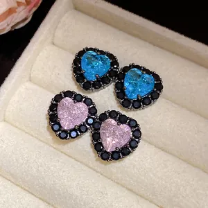Close-up view of elegant heart-shaped zircon earrings with black micro-pave halo