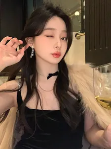 Model wearing elegant French style zircon teardrop tassel earrings in a warm setting