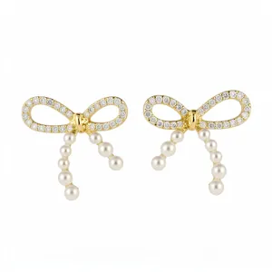 Luxury 14k gold plated bow knot stud earrings with white pearls and sparkling crystals