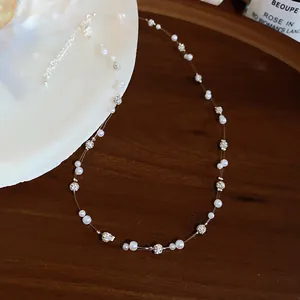 Close-up of elegant pearl necklace with sparkling spacers on a warm wooden background