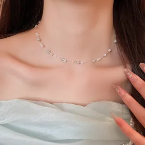 Close-up view of an elegant pearl and sparkling bead choker necklace on a female model