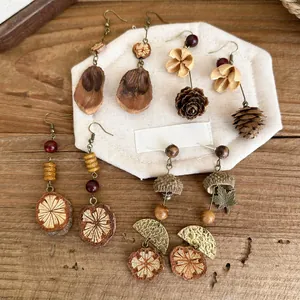 Detailed macro shot of handmade vintage fruit beaded earrings with wood accents