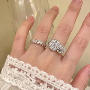Elegant silver color zirconia twisted braided open ring and star pavé ring on hand model