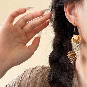 Vintage natural fruit cone dangle earrings for women in ethnic style on Asian model
