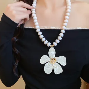 Detail view of French vintage beaded necklace with a large pearly white flower pendant