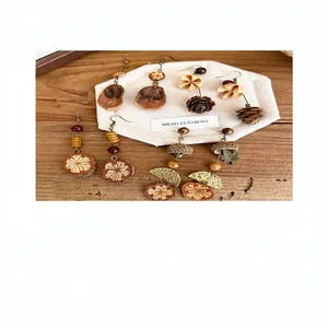 Close-up detail of retro ethnic style fruit and pinecone beaded dangle earrings set on wood