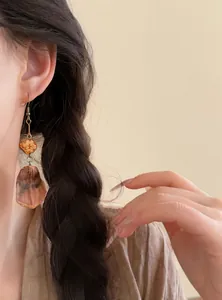 Close-up of retro fruit beaded tassel earrings on model with ethnic style design