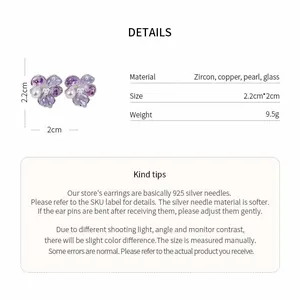 Detail view of purple flower stud earrings with zircon and pearls on 925 silver needles.