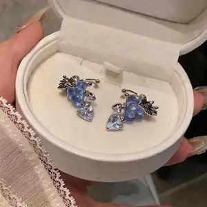Elegant blue zircon grape and heart-shaped ear clips presented in a white jewelry box