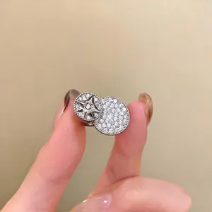 Macro view of silver open ring featuring a sparkling star motif and zircon-paved discs