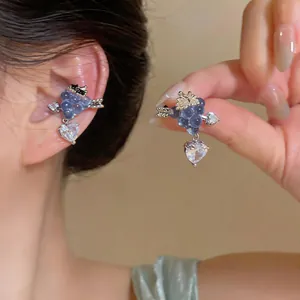 Detailed macro view of purple grape ear cuff featuring a clear heart-shaped zircon pendant.