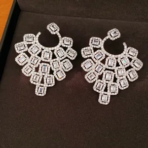 Close-up of elegant silver geometric earrings set with sparkling square zircons
