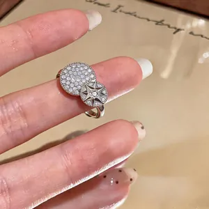 Detailed shot of silver-tone open ring featuring pave zircon and starburst motif