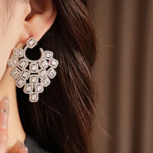 Detailed close-up view of premium geometric square zirconia earrings worn by a model