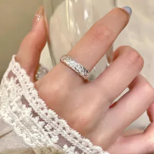 Detailed close-up of a twisted braided silver ring featuring sparkling zircon stones