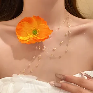 Close-up view of a sweet orange poppy flower beaded tassel necklace on a model's neck