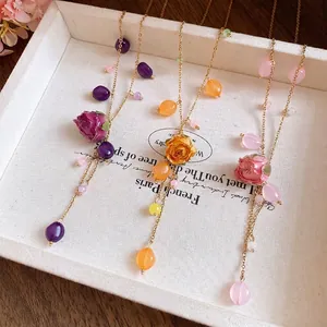 Elegant stainless steel necklaces featuring colorful resin beads and dried rose petals