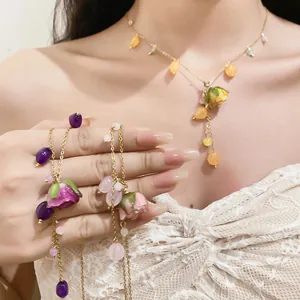 Detail of handmade resin rose petal tassel necklaces with colorful crystal beads