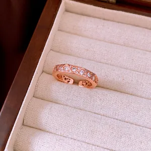 Macro view of a luxury rose gold vintage ring with a sparkling diamond-encrusted pattern.