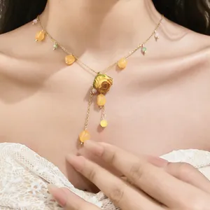 Detailed view of a stainless steel necklace featuring a yellow eternal flower and resin beads.