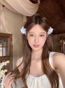 Un beau mannequin portant des barrettes à fleurs en tissu blanc dans un décor rustique