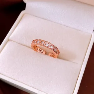 Macro view of vintage rose gold rhombus ring with sparkling crystals in white box