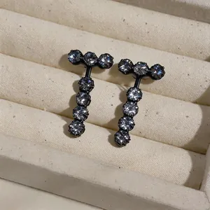 Macro view of T-shaped earrings with sparkling cubic zirconia in black setting