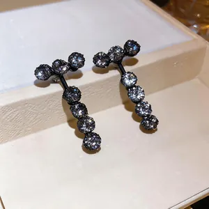 Detailed view of luxury zircon drop earrings with round pendant design in black finish.