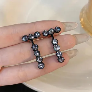 Detailed view of elegant black drop earrings with shimmering round zircon stones