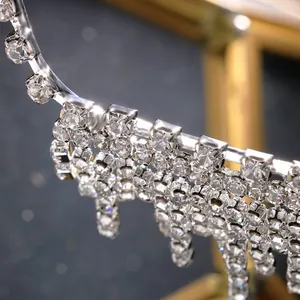 Close-up detail of shimmering silver rhinestone tassels on fashion eyewear frames.