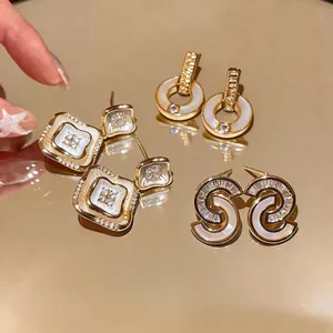 Elegantes pendientes de botón de nácar y circonitas con acabado dorado estilo francés